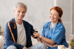 nurse checking the blood pressure of a senior
